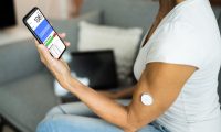 patient using continuous glucose monitor